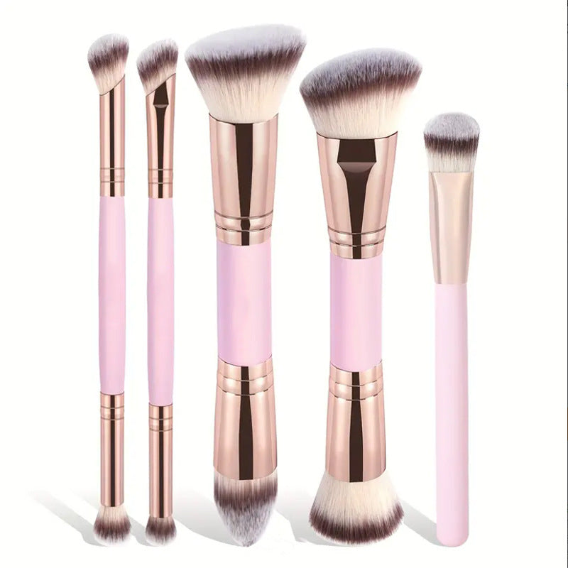 Set of makeup brushes with pink and rose gold handles on a white background