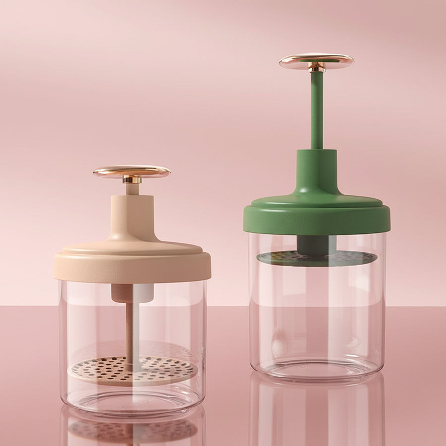 Two kitchen presses, one beige and one green, on a light blue background with plants.