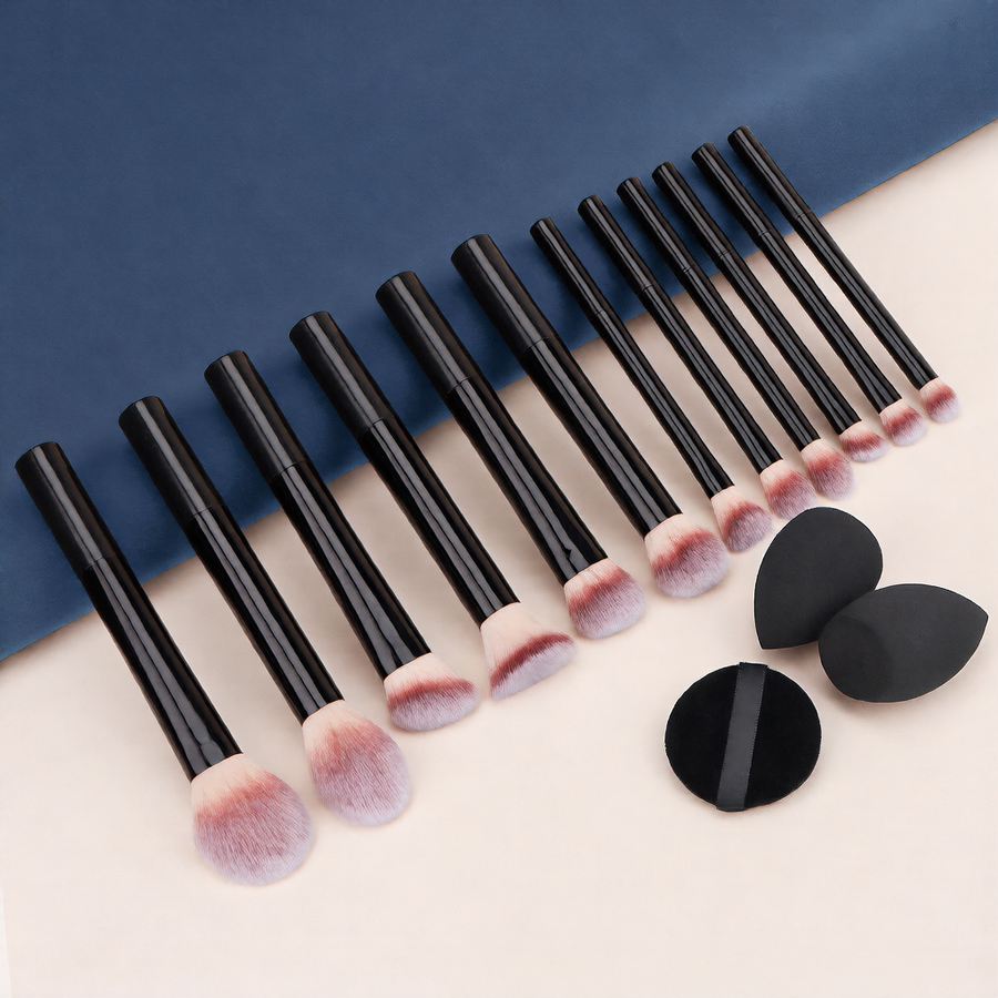 Set of makeup brushes with black handles and pink bristles, accompanied by three black makeup sponges on a blue and beige background.