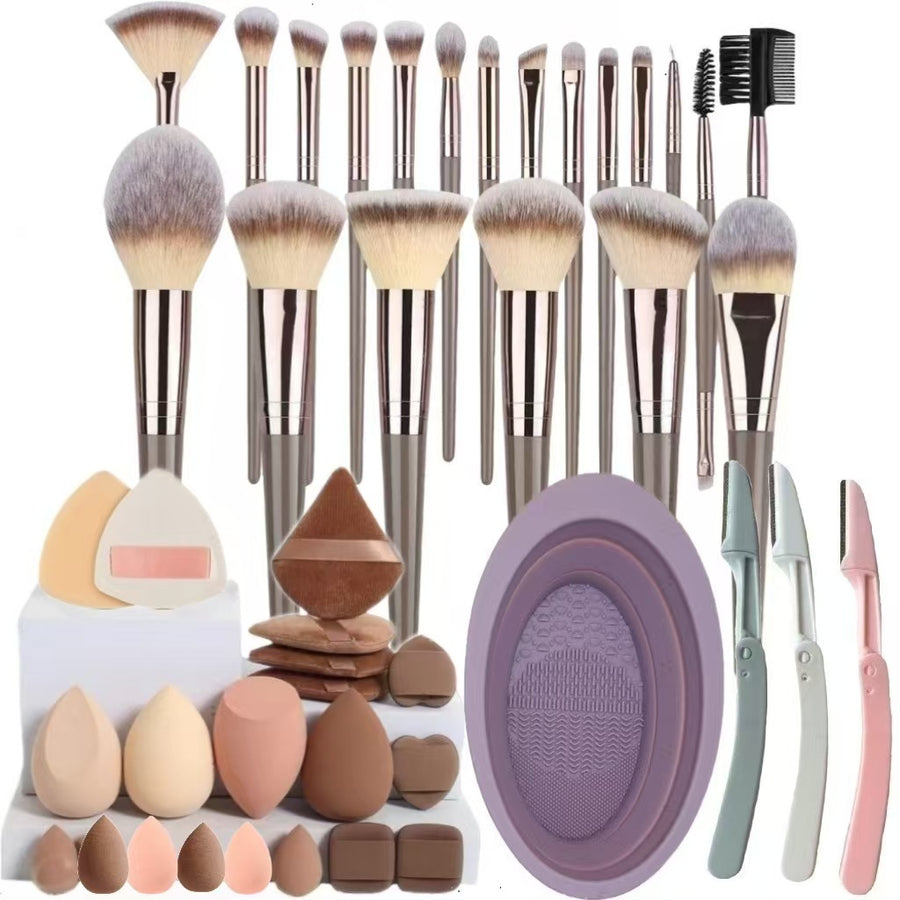 Collection of makeup brushes, sponges, and tools on a white background