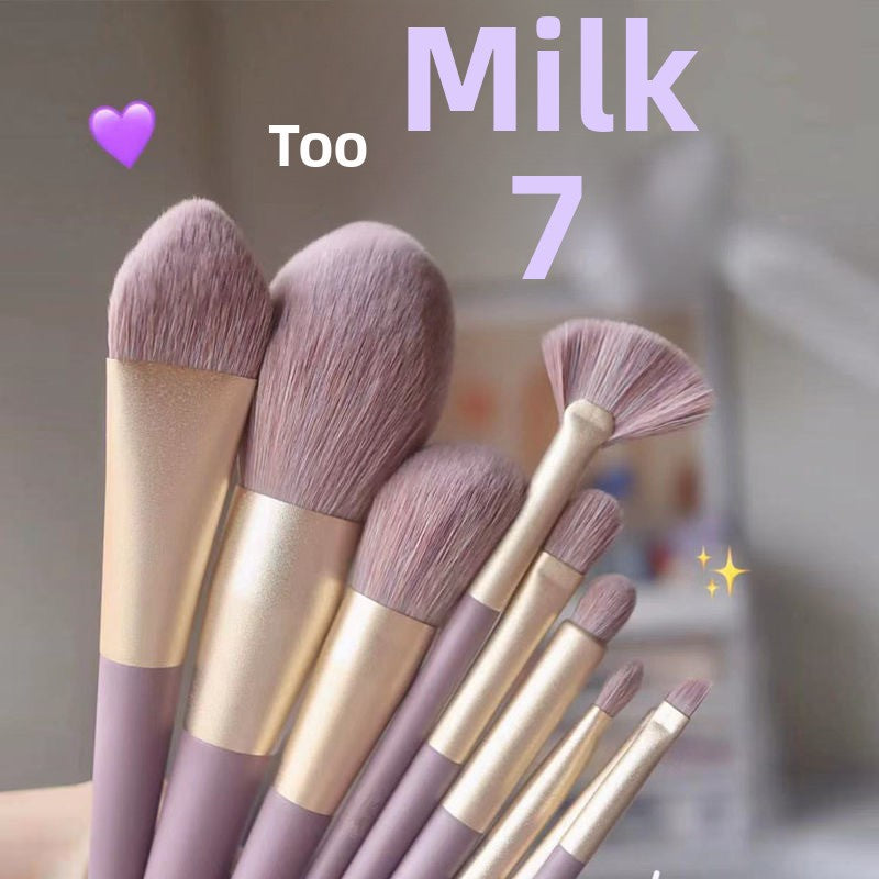 Set of makeup brushes with purple bristles and gold handles, labeled 'Too Milk 7'.